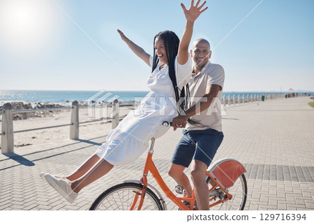 Bicycle, beach and couple with freedom, travel and summer holiday in city sidewalk for wellness, love and care in sunshine. Mental health, black woman and cycling partner at ocean on blue sky mockup Bicycle, beach and couple with freedom, travel and summer holiday in city sidewalk for wellness, love and care in sunshine. Mental health, black woman and cycling partner at ocean on blue sky mockup 129716394