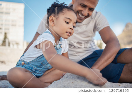 Beach, father and girl play with sand as a happy family bonding on a fun summer holiday vacation in Brazil. Smile, travel of dad enjoying quality time with a young playful child or kid on beach sand Beach, father and girl play with sand as a happy family bonding on a fun summer holiday vacation in Brazil. Smile, travel of dad enjoying quality time with a young playful child or kid on beach sand 129716395
