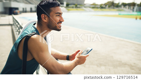 Happy, athlete and man with smartphone, stadium and sportswear for fitness, think and workout break. Outdoor, runner and planning for marathon, wellness and person with mobile, wonder or reflection 129716514