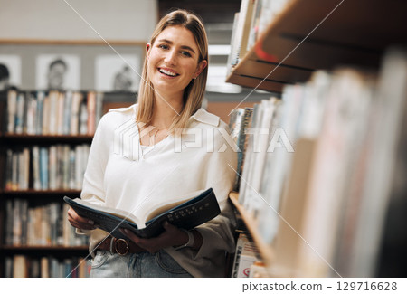 Student, reading or books in library on school, university or college campus for education, study research or learning. Portrait, smile or happy woman, textbook or bookshelf information for homework 129716628