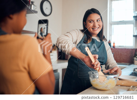 Baking, tutorial and social media with a chef woman in the kitchen of her home cooking as an influencer. Food, phone and vlog with a female cook preparing baked goods while live streaming in a house 129716681