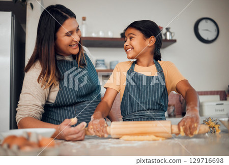 Family, mother and girl learning baking in kitchen, bonding and having fun. Food, cooking education and mom teaching chef kid how to bake delicious pastry, smiling and enjoying quality time together. Family, mother and girl learning baking in kitchen, bonding and having fun. Food, cooking education and mom teaching chef kid how to bake delicious pastry, smiling and enjoying quality time together. 129716698