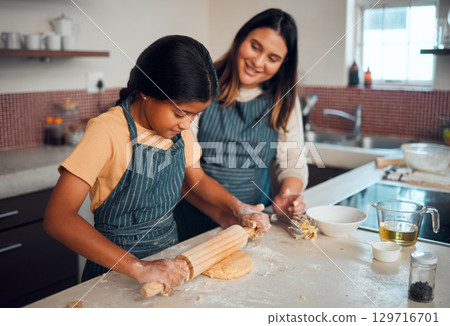 Mom, girl and kitchen for teaching, rolling pin or cookies for baking, bonding love and family home. Mama, daughter and cooking for learning support, holiday or celebration for festive party in house 129716701