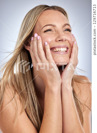 Woman, cosmetics and hair care with smile, relax and treatment on grey studio background. Female, girl and clean scalp for stylish hair, casual or glow for smooth, shine or grooming for style or face 129716713