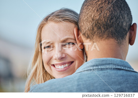 Couple, interracial with hug, love and travel, woman smile with black man, commitment and relationship with outdoor bonding. Face zoom, happy and romance in nature, trust and care with support. 129716837