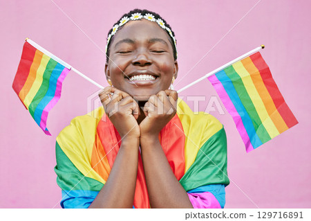 Pride, lgbtq and black woman with flags in studio for queer rights. Freedom, homosexual and face of happy, lesbian or bisexual female from Nigeria with rainbow flag showing support for gay community. 129716891
