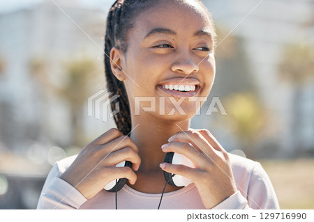 Start, fitness or black woman with headphones in nature or park ready for training, exercise or workout in Miami. Sports, healthy or happy girl athlete smiles before running outdoors in summer alone Start, fitness or black woman with headphones in nature or park ready for training, exercise or workout in Miami. Sports, healthy or happy girl athlete smiles before running outdoors in summer alone 129716990