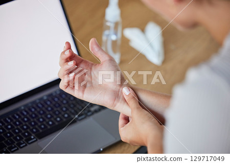 Wrist, pain and woman at laptop working with injury, arthritis or carpal tunnel syndrome concern. Inflammation, uncomfortable and injured girl with medical problem at table with screen mockup. Wrist, pain and woman at laptop working with injury, arthritis or carpal tunnel syndrome concern. Inflammation, uncomfortable and injured girl with medical problem at table with screen mockup. 129717049