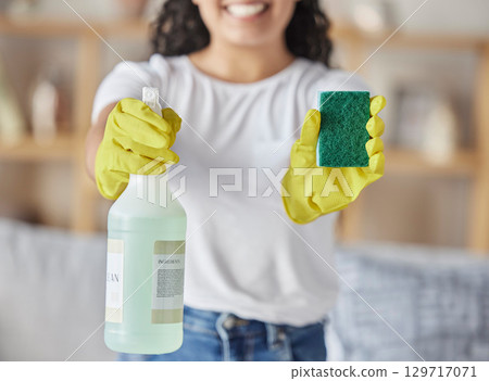Sponge, spray and woman with cleaning products in home for hygiene, health and wellness. Spring cleaning, housekeeper and happy female holding equipment for washing, sanitizing or disinfecting house. 129717071