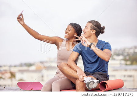 Couple, fitness and selfie with a peace sign after exercise for a social media post or blog update while outdoor in city with a smile and support. Man and black woman together for a workout in France Couple, fitness and selfie with a peace sign after exercise for a social media post or blog update while outdoor in city with a smile and support. Man and black woman together for a workout in France 129717175