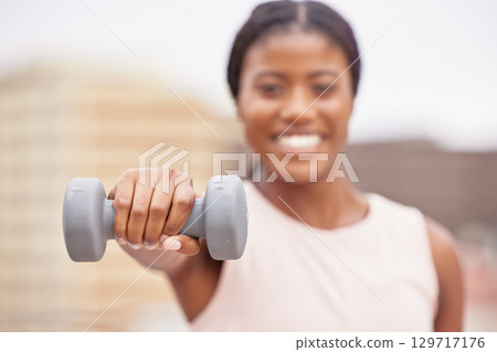 Dumbell, exercise and black woman does fitness workout for muscle growth, body health and strength training on a blurred background rooftop. Sports athlete, healthy and strong African American girl 129717176
