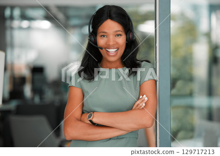 Black woman, call center and smile while in a office for CRM, customer support and telemarketing sales with arms crossed as leader or manager. Portrait of a happy entrepreneur with consultant headset Black woman, call center and smile while in a office for CRM, customer support and telemarketing sales with arms crossed as leader or manager. Portrait of a happy entrepreneur with consultant headset 129717213