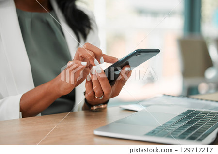 Phone, office and business woman networking on social media, the internet or a mobile app. Technology, corporate and professional company leader browsing on a mobile device in her modern workplace. Phone, office and business woman networking on social media, the internet or a mobile app. Technology, corporate and professional company leader browsing on a mobile device in her modern workplace. 129717217
