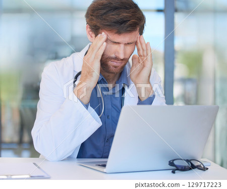 Headache, burnout and doctor in hospital office feeling pain or migraine while working on laptop. Mental health, anxiety and medical physician from Canada with stress or depression after surgery fail Headache, burnout and doctor in hospital office feeling pain or migraine while working on laptop. Mental health, anxiety and medical physician from Canada with stress or depression after surgery fail 129717223