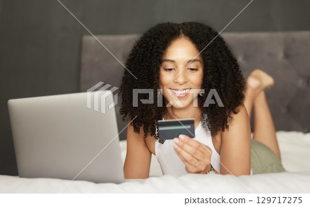 Credit card, online shopping or black woman on bed with laptop for bill payment, ecommerce or investment. Happy, crypto or girl relax in bedroom for trading, bitcoin invest or digital banking app 129717275