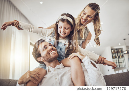 Family, bonding and airplane game in living room, house or relax home in freedom activity, kids energy or fun playing. Smile, happy and flying child on father shoulders in fantasy support with mother 129717278