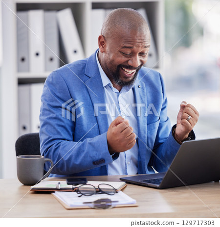 Happy, excited and black man at laptop in office, celebrate success and good news on online deal. Wow, email surprise and approved financial loan for ecommerce startup and winning with sales results. Happy, excited and black man at laptop in office, celebrate success and good news on online deal. Wow, email surprise and approved financial loan for ecommerce startup and winning with sales results. 129717303