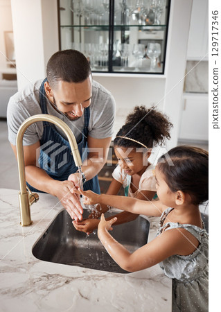 Love, father and girls washing hands, happiness and bonding together in kitchen, before cooking and hygiene. Family, dad and female children cleaning, happy and teaching kids at home loving and learn Love, father and girls washing hands, happiness and bonding together in kitchen, before cooking and hygiene. Family, dad and female children cleaning, happy and teaching kids at home loving and learn 129717346