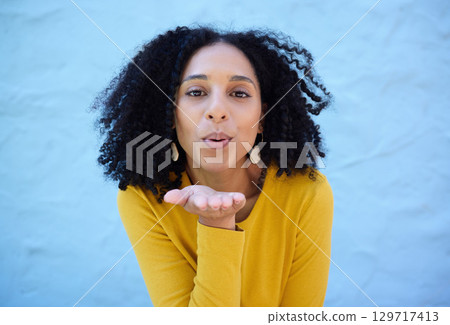 Black woman, portrait and blowing kiss for love, care and flirting on blue background, wall backdrop or outdoor. Young girl, hand kisses and expression of happiness, romance and kissing face emoji Black woman, portrait and blowing kiss for love, care and flirting on blue background, wall backdrop or outdoor. Young girl, hand kisses and expression of happiness, romance and kissing face emoji 129717413