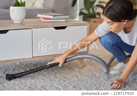 Woman, cleaning and vacuum machine for carpet in house, home or hotel living room in hygiene maintenance or housekeeping. Maid, cleaner service or worker with suction on floor rug for spring cleaning 129717420