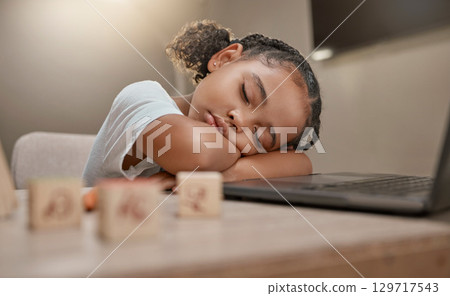 Child sleeping, learning and girl tired from home education, computer and kid development. Study, sleep and online education of a student in a house rest after digital school studying and working 129717543