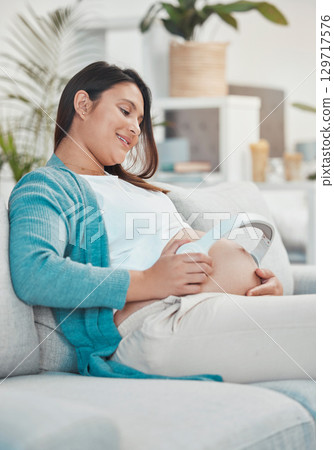 Pregnant, mother and headphones on stomach for baby to listen to music for relax and growth. Musical audio, headset and pregnancy with a woman playing songs or the radio for her unborn child Pregnant, mother and headphones on stomach for baby to listen to music for relax and growth. Musical audio, headset and pregnancy with a woman playing songs or the radio for her unborn child 129717576