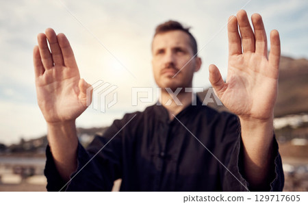 Karate, martial arts and hands of man doing tai chi workout, balance training and sports exercise. Motivation, fitness and male athlete with focus for mindfulness, wellness and zen energy by sea 129717605