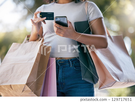 Credit card, sale and phone with black woman, luxury boutique for customer or online purchase in city. Female customer, online payment or clothes in bag from retail gifts in town market trip in paris 129717651