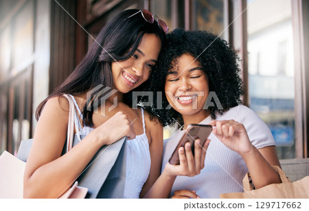 Women friends, shopping and phone in city for choice, e commerce discount or online shopping. Happy black woman, group smile and smartphone for web store, sale or ecommerce together in Los Angeles 129717662
