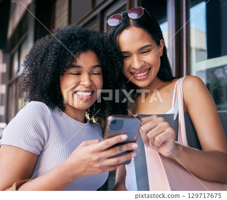 Women, phone and online shopping in Cape Town street, read ecommerce website on retail shopping app in city. Happy friends, black woman and mobile tech, customer or promo notification on smartphone Women, phone and online shopping in Cape Town street, read ecommerce website on retail shopping app in city. Happy friends, black woman and mobile tech, customer or promo notification on smartphone 129717675