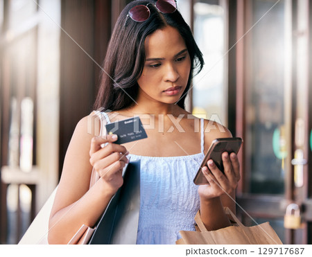 Credit card, online shopping and woman with smartphone in city street for finance, loan and wealth with fintech, e commerce and retail app. Girl with shopping bag, digital payment and phone banking Credit card, online shopping and woman with smartphone in city street for finance, loan and wealth with fintech, e commerce and retail app. Girl with shopping bag, digital payment and phone banking 129717687