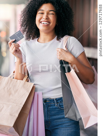 Credit card, shopping and black woman with financial payment, retail therapy and luxury at outdoor city for commerce, economy and budget. Finance, banking and excited or happy woman holiday shopping 129717688