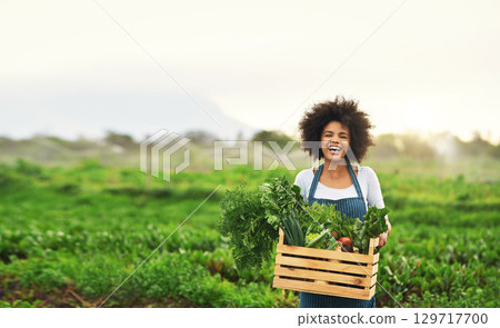 Agriculture, farm and portrait of black woman with vegetables, natural produce and organic food in field. Sustainability, agribusiness and farmer with box for eco farming, gardening and harvesting 129717700