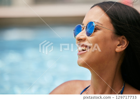 Woman, face sunglasses and laughing by pool on summer break, holiday vacation or tropical travel fun. Mockup, happy smile or tourist student with fashion accessory by hotel or luxury resort water 129717733