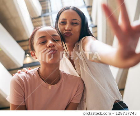 Peace, kiss and pout with black woman friends in the city together, posing with a hand sign or gesture. Happy, smile and bonding with a young female and her best friend in an urban town from below Peace, kiss and pout with black woman friends in the city together, posing with a hand sign or gesture. Happy, smile and bonding with a young female and her best friend in an urban town from below 129717743