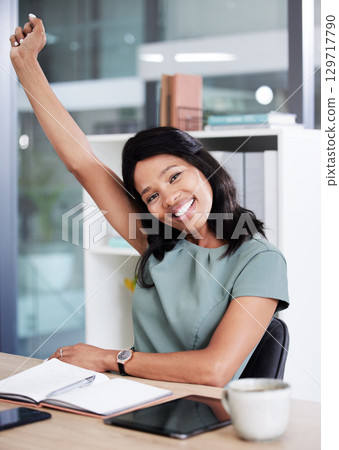 Portrait, success and celebration of black woman in office after achievement of goals, targets or task. Winner, business woman and happy female employee from Nigeria celebrating victory in workplace. 129717790