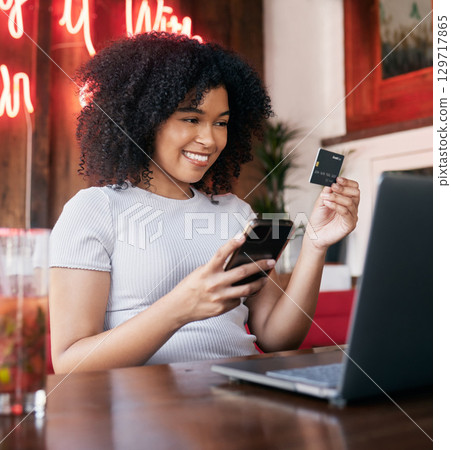 Credit card, phone and woman on laptop in cafe online shopping, ecommerce website payment for fashion sale. Black woman, retail customer and smartphone bank app or internet finance in coffee shop Credit card, phone and woman on laptop in cafe online shopping, ecommerce website payment for fashion sale. Black woman, retail customer and smartphone bank app or internet finance in coffee shop 129717865