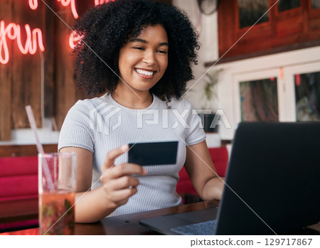 Woman, credit card and laptop in cafe, ecommerce and discount purchase. Young black woman, girl and female customer online shopping, expensive products and sale for consumer, buying and restaurant. 129717867