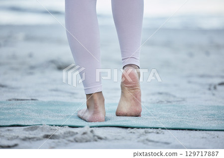 Woman, bare feet and beach yoga exercise, workout and stretching ankle on sand for zen energy, healthy lifestyle or body wellness. Closeup, foot and fitness at ocean for pilates, balance and training 129717887