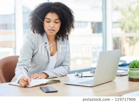 Lawyer, black woman and writing in book at office for legal client appointment note reminder in Chicago, USA. Organisation of corporate attorney girl in professional workplace with diary schedule. Lawyer, black woman and writing in book at office for legal client appointment note reminder in Chicago, USA. Organisation of corporate attorney girl in professional workplace with diary schedule. 129717906