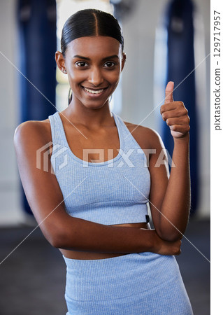 Thumbs up, Indian woman and fitness, wellness and exercise health model with positive energy in gym. Motivation, encouragement and support for happy training workout, sports athlete and healthy goal 129717957