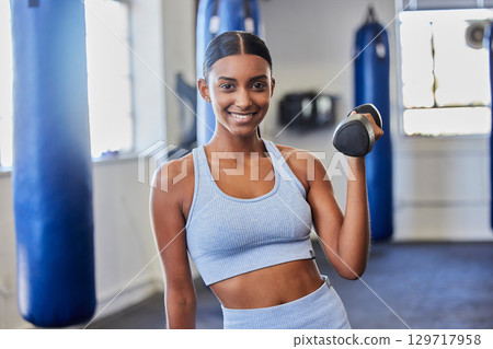 Happy woman, fitness and dumbbell exercise in gym for strong body, wellness and healthy lifestyle goals. Portrait of indian female, sports and happiness with weights for workout, training and power Happy woman, fitness and dumbbell exercise in gym for strong body, wellness and healthy lifestyle goals. Portrait of indian female, sports and happiness with weights for workout, training and power 129717958