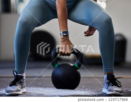 Woman hand, kettlebell and gym floor in training, fitness or muscle development with smartwatch. Bodybuilder girl, weightlifting and strong with sneakers, chalk powder and focus on exercise in studio 129717966