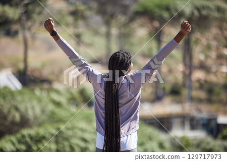 Fitness success, winner woman and a forest for marathon competition, exercise training or nature hiking with yes, goal and energy. Winning hands sign of sports athlete, runner or black woman in woods 129717973