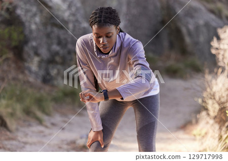 Fitness, nature and woman with time on watch for running speed, progress check and steps monitor on smartwatch or digital technology. Runner, athlete or black woman in mountains training with a timer Fitness, nature and woman with time on watch for running speed, progress check and steps monitor on smartwatch or digital technology. Runner, athlete or black woman in mountains training with a timer 129717998