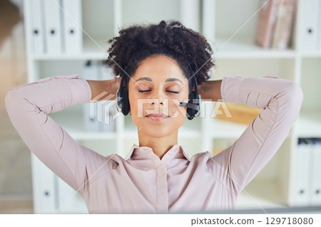 Relax, call center or tired black woman sleeping at customer services resting at customer services office desk. Nap, breathing or exhausted telemarketing agent relaxing at contact support on a break 129718080