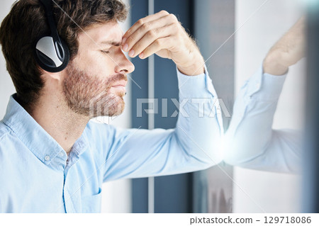 Headache, stress and call center man in office feeling exhausted, tired or fatigue. Crm, customer service and male telemarketing consultant with depression, anxiety and burnout in company workplace. Headache, stress and call center man in office feeling exhausted, tired or fatigue. Crm, customer service and male telemarketing consultant with depression, anxiety and burnout in company workplace. 129718086