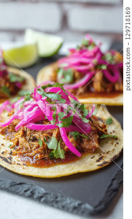 shot of delicious tacos. The vivid pink of the pickled onions contrasts beautifully with the rich brown of the pork, making this image perfect for food blogs, restaurant menus, and culinary promotions shot of delicious tacos. The vivid pink of the pickled onions contrasts beautifully with the rich brown of the pork, making this image perfect for food blogs, restaurant menus, and culinary promotions 129718169