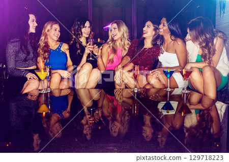 Cocktail, friends and party with women in nightclub for celebration, music and concert event. Relax, energy and social with group of girls drinking in happy hour for rave, new year and disco festival 129718223