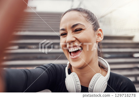 Woman, face and selfie with headphones and exercise in city, happy in Brazil, laughter and fitness outdoor. Runner, cardio and happiness in picture, health and wellness with active lifestyle 129718278